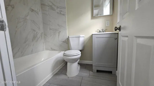 a bathroom with a toilet and a bathtub