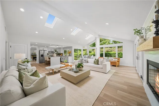 a living room with fireplace furniture and a large window