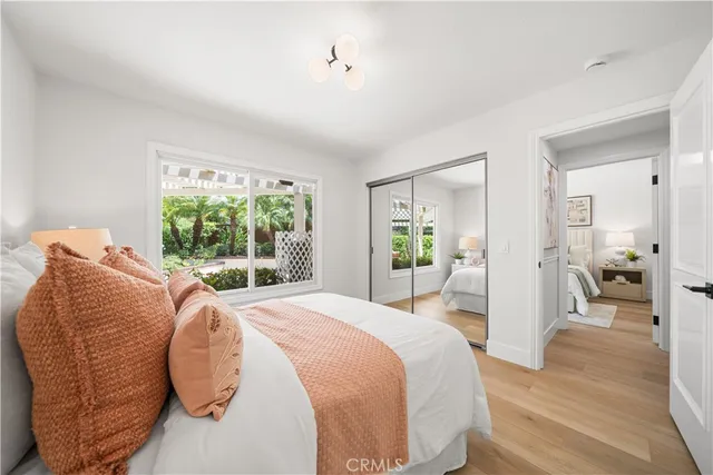 a dining room with furniture large windows and wooden floor