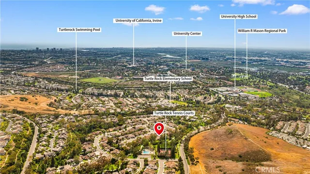 a view of a house with a window and potted plants
