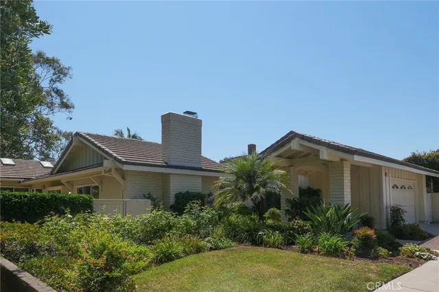a view of a house with a window and potted plants