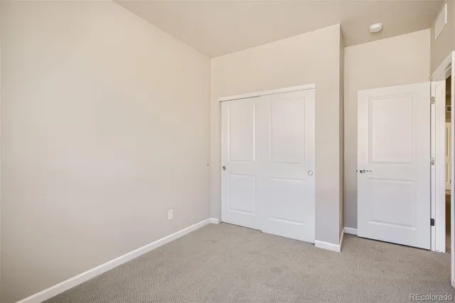 an empty room with closet area