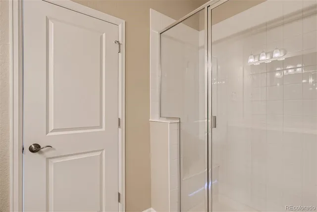 a bathroom with a glass shower door