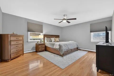 a bedroom with a large bed and a tv