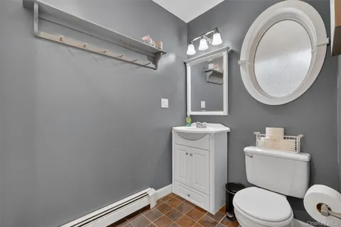 a bathroom with a toilet a sink and a mirror