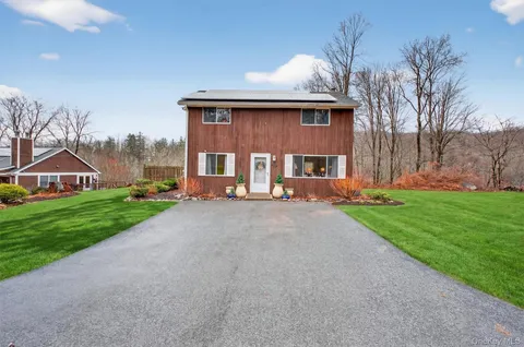 a front view of a house with a yard and pathway
