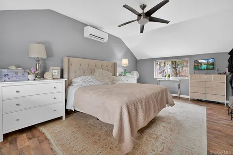a spacious bedroom with a bed and a ceiling fan