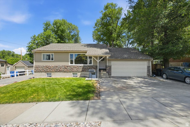 565 East 800 North Logan, UT 84321 - Photo 3 of 27 Split-level residence featuring a composite shingle roof and a combination of horizontal siding and stone veneer