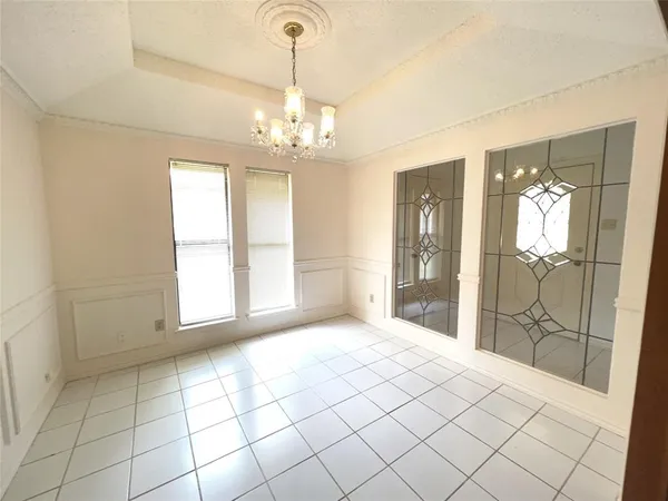 a view of an empty room with a chandelier