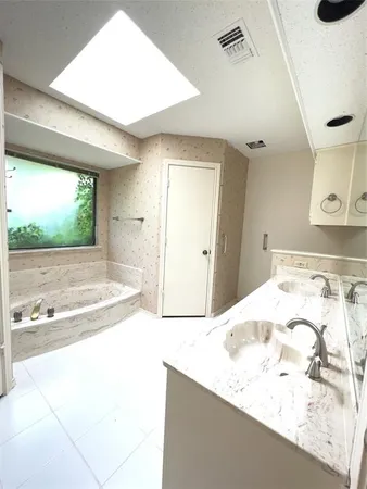 a bathroom with a bathtub and a sink