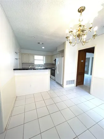 a kitchen with a sink and a refrigerator