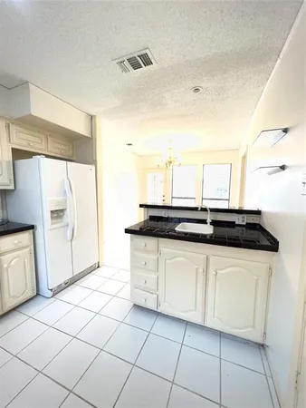a kitchen with a sink and a stove top oven