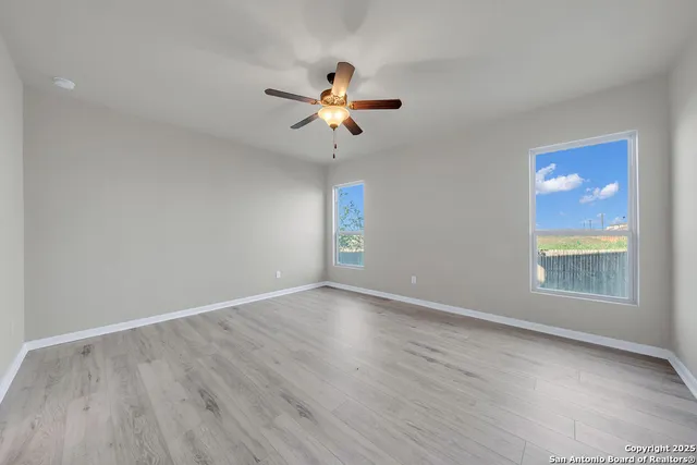 wooden floor in an empty room with a window