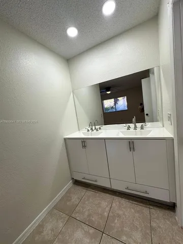 a bathroom with a sink a mirror and vanity
