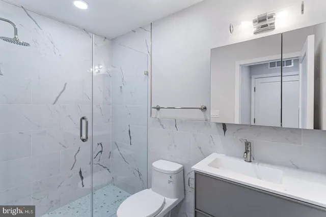a bathroom with a toilet sink and shower
