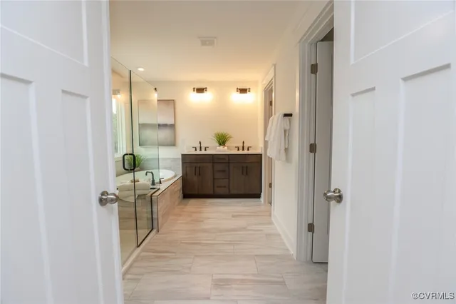 a bathroom with a granite countertop tub sink and mirror