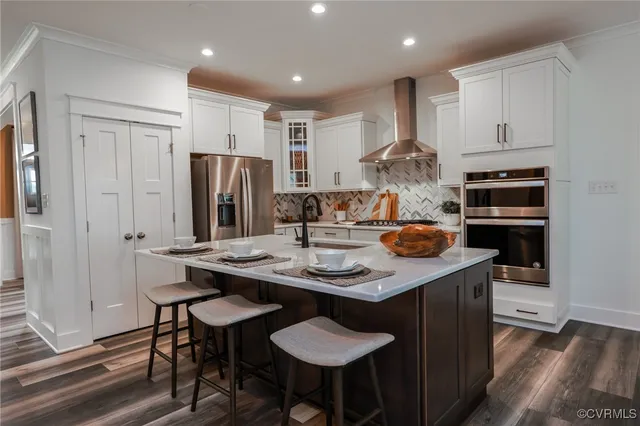 a kitchen with stainless steel appliances granite countertop a sink and a refrigerator