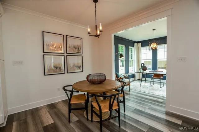 a living room with furniture kitchen view and a chandelier