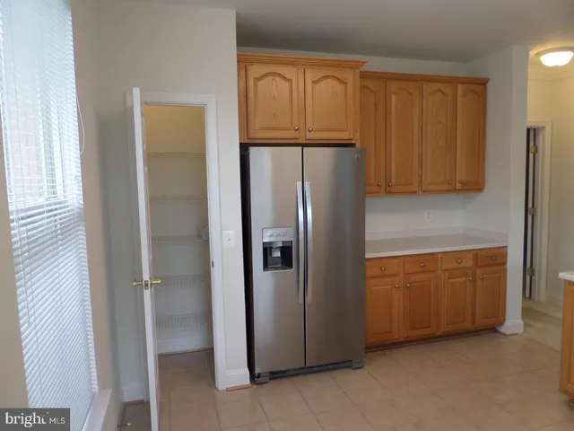 a kitchen with a refrigerator sink and cabinets