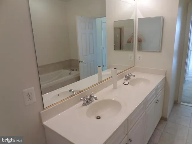 a bathroom with a sink double vanity and a mirror
