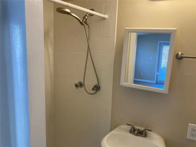 a bathroom with a shower and a sink