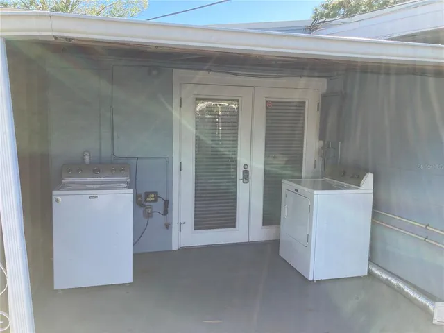 a utility room with closet dryer and washer