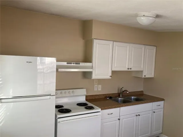 a white refrigerator freezer sitting inside of a kitchen