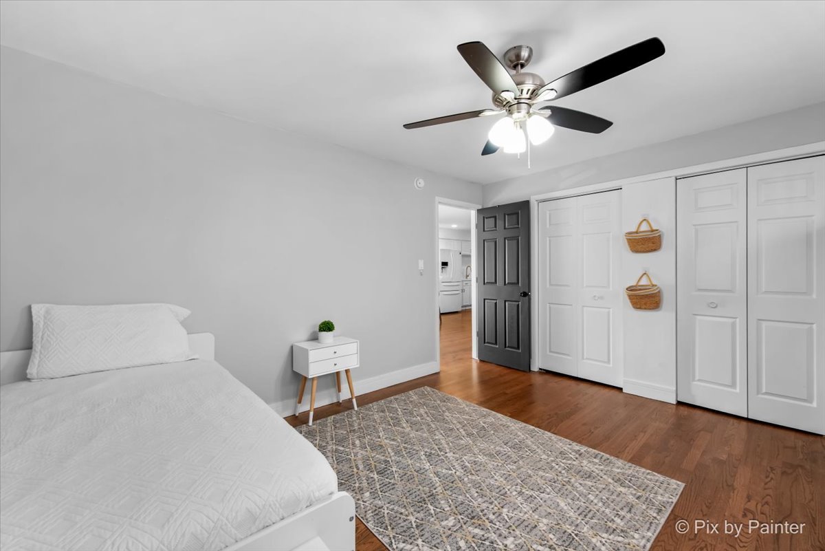 3121 Paris Avenue, Unit 304 River Grove, IL 60171 - Photo 11 of 16 a bedroom with a bed and a ceiling fan