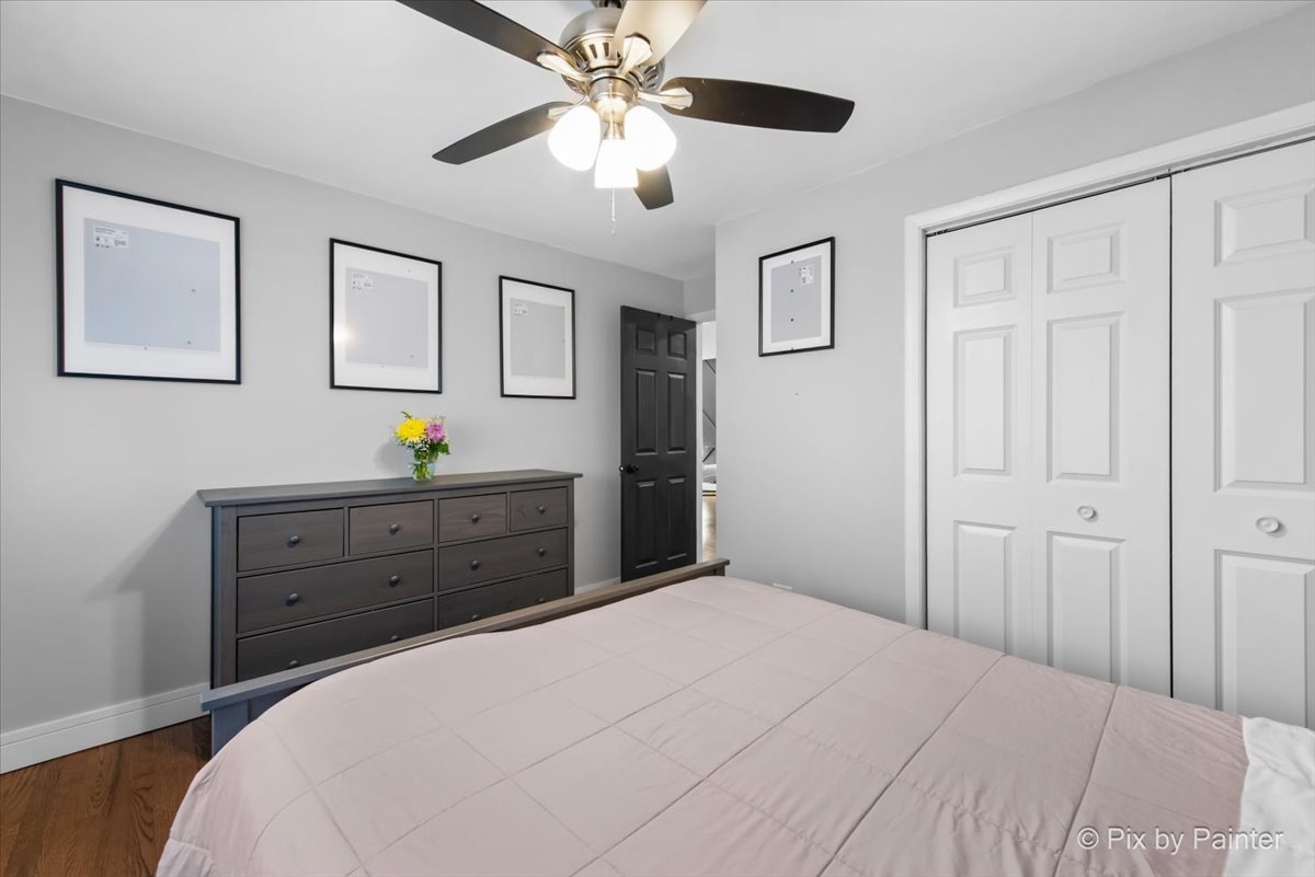 3121 Paris Avenue, Unit 304 River Grove, IL 60171 - Photo 13 of 16 a bedroom with a bed and a chandelier