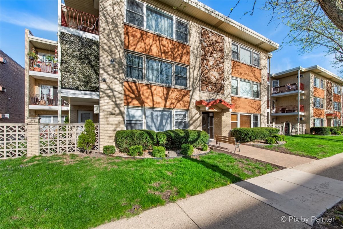 3121 Paris Avenue, Unit 304 River Grove, IL 60171 - Photo 15 of 16 front view of a brick house with a yard