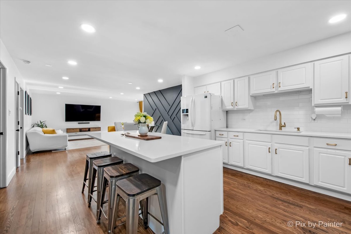 3121 Paris Avenue, Unit 304 River Grove, IL 60171 - Photo 2 of 16 a kitchen with a sink stainless steel appliances and white cabinets