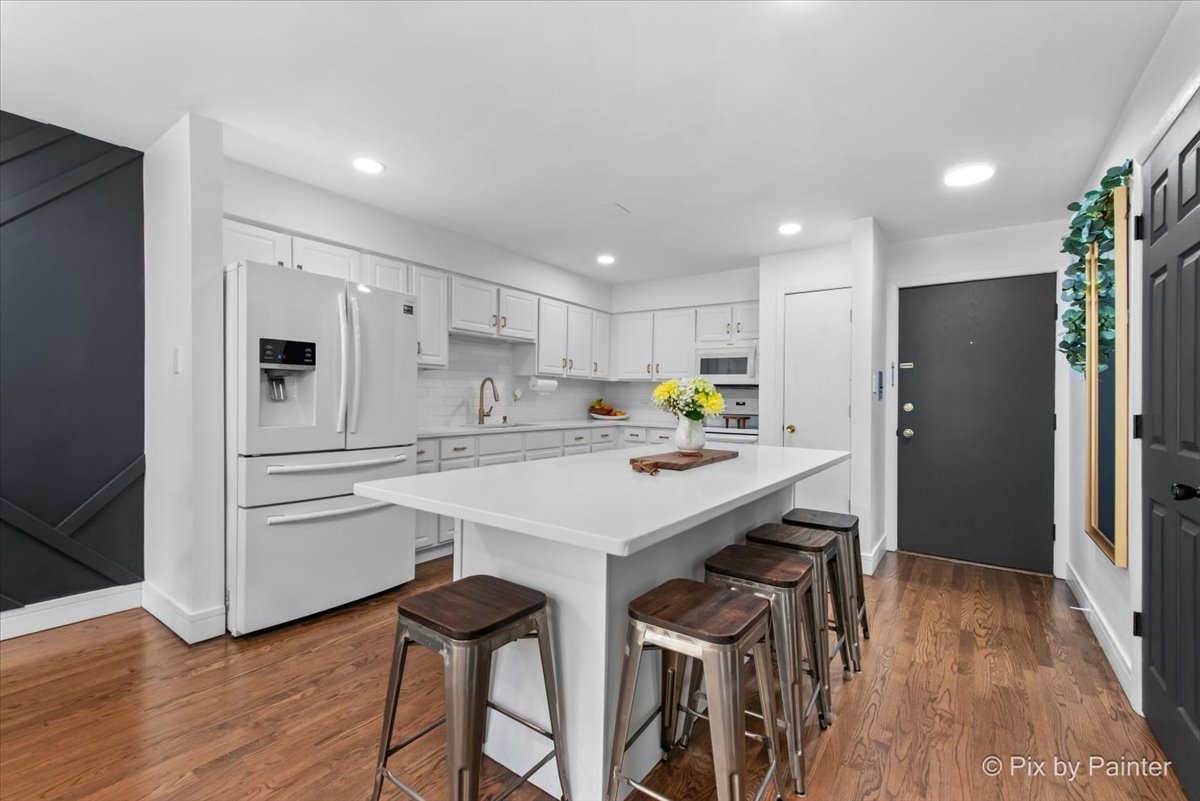 3121 Paris Avenue, Unit 304 River Grove, IL 60171 - Photo 5 of 16 a kitchen with white cabinets and refrigerator