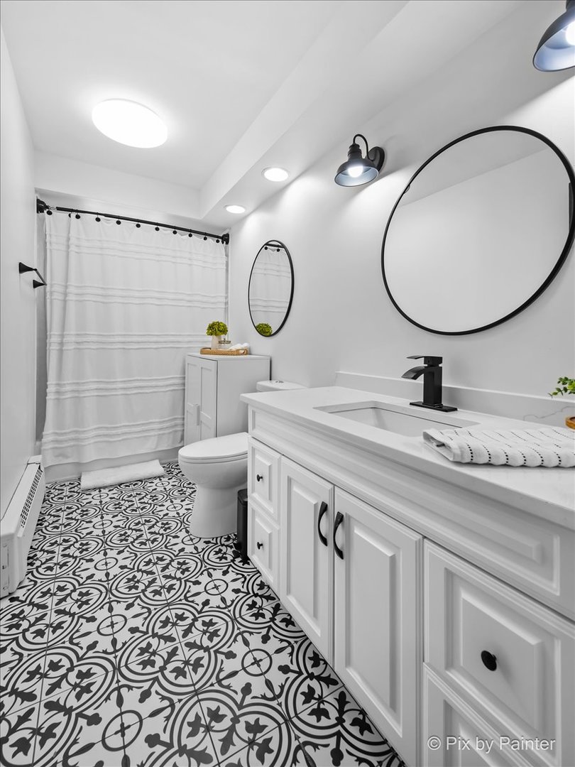 3121 Paris Avenue, Unit 304 River Grove, IL 60171 - Photo 9 of 16 a bathroom with a toilet a sink and a mirror