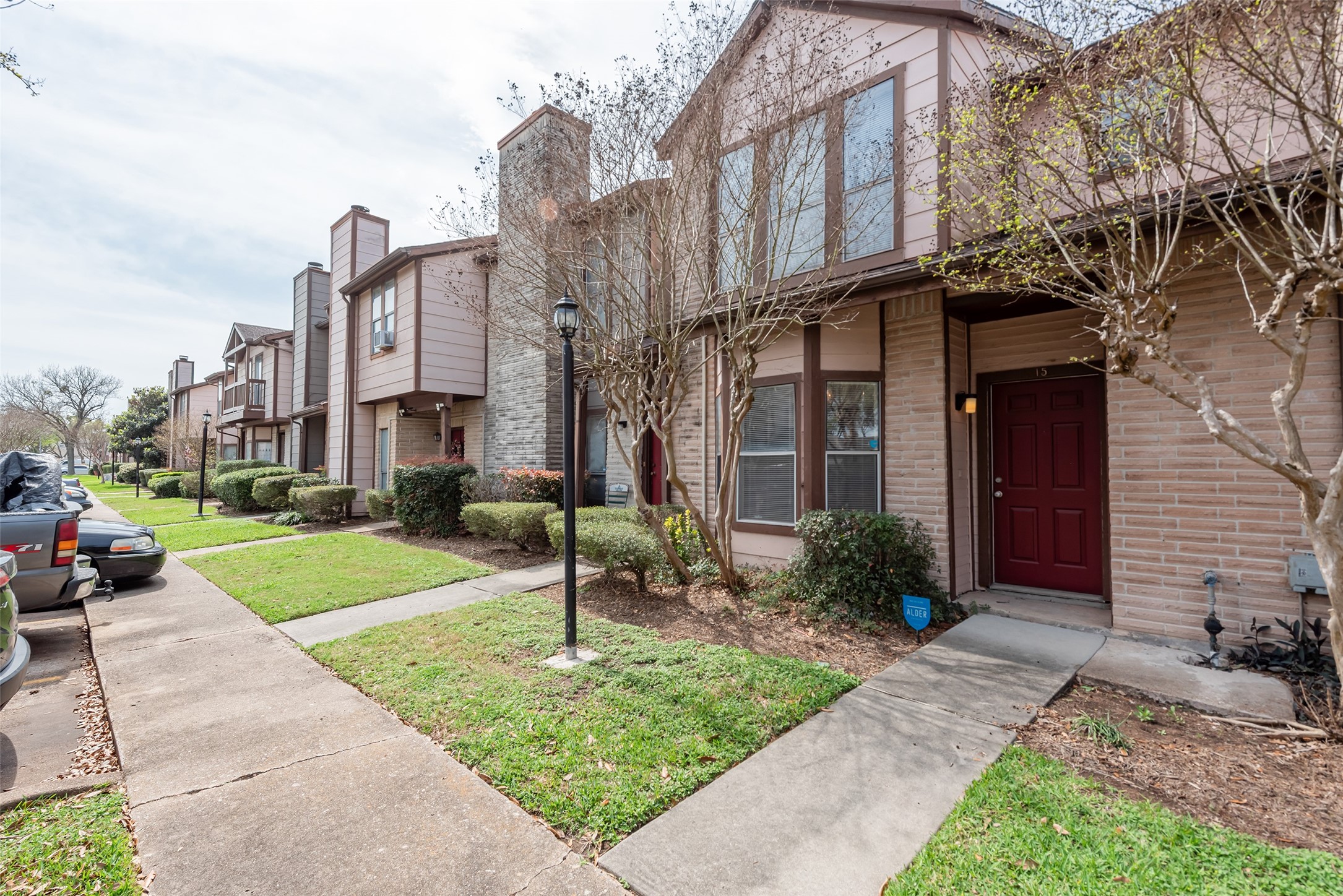 12400 Brookglade Circle, Unit 15 Houston, TX 77099 - Photo 1 of 43 a front view of a house with garden