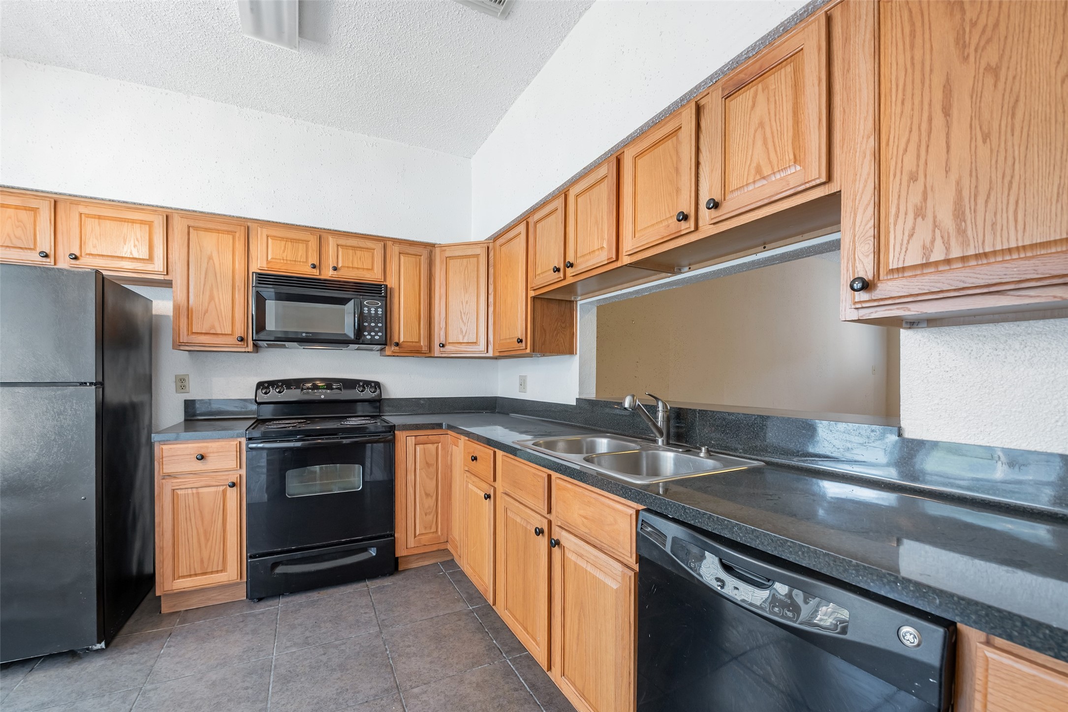 12400 Brookglade Circle, Unit 15 Houston, TX 77099 - Photo 15 of 43 a kitchen with stainless steel appliances granite countertop a sink stove and refrigerator