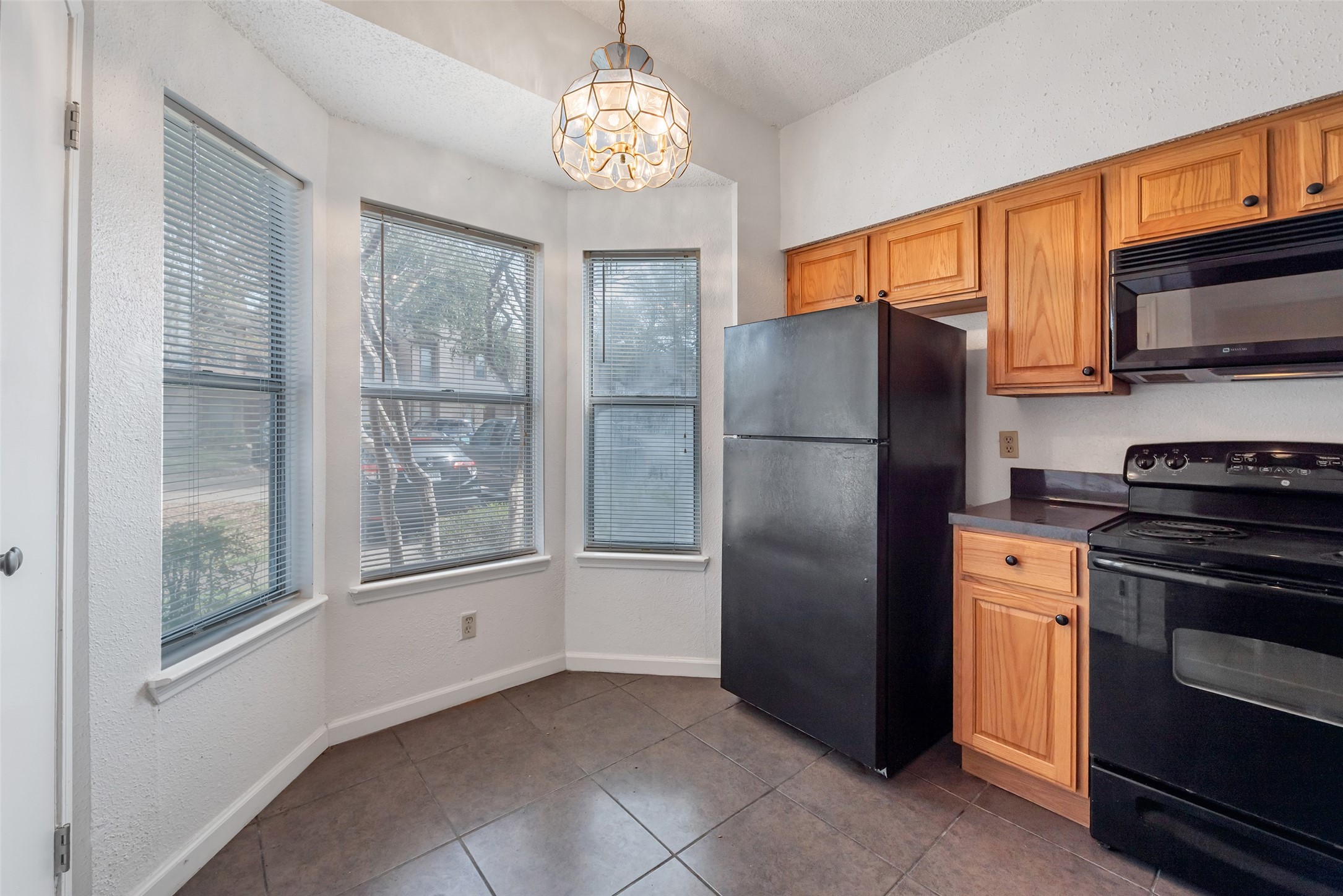 12400 Brookglade Circle, Unit 15 Houston, TX 77099 - Photo 18 of 43 a kitchen with stainless steel appliances granite countertop a refrigerator and a stove top oven