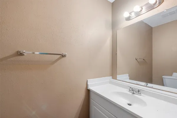 an empty room with a ceiling fan and a window