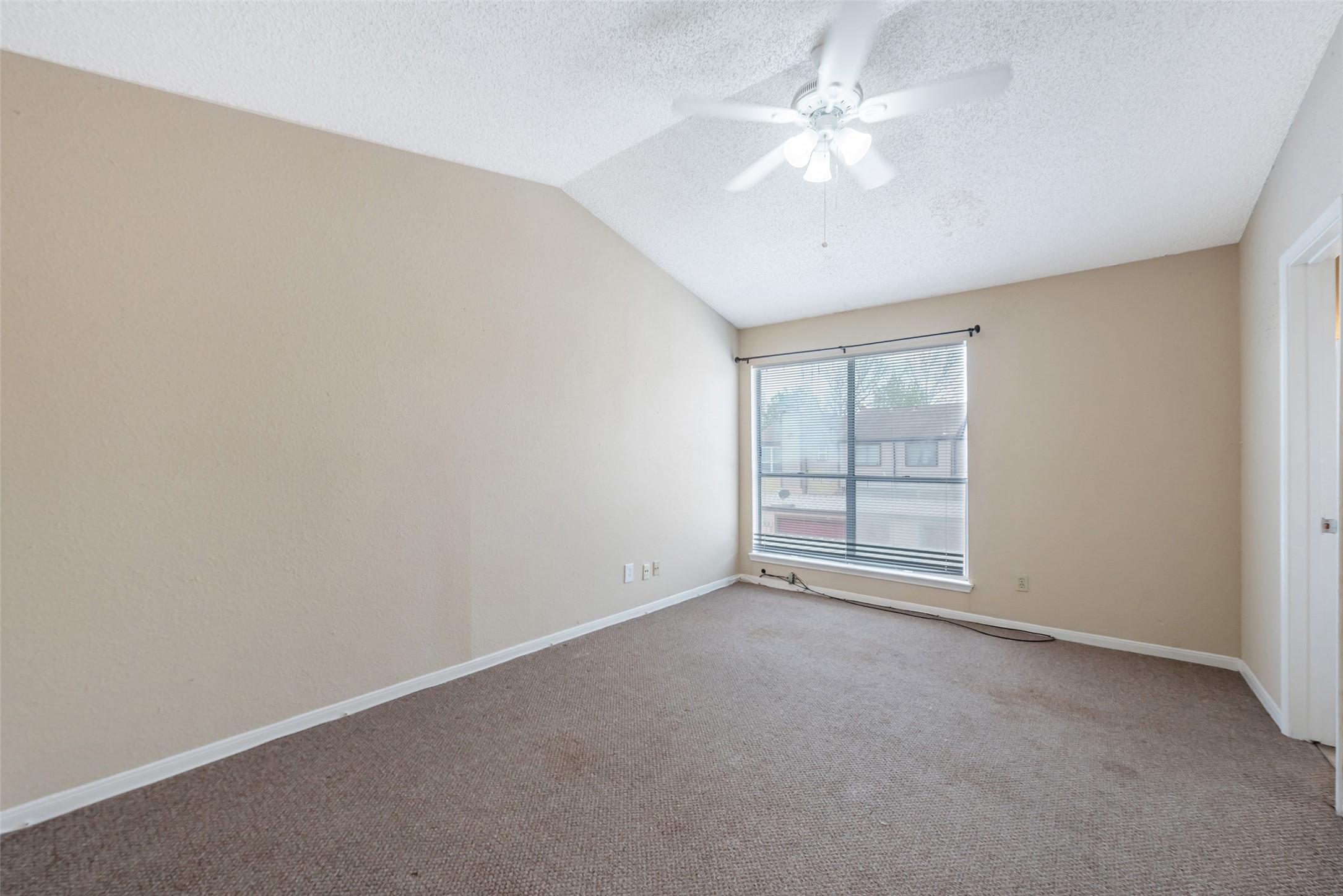 12400 Brookglade Circle, Unit 15 Houston, TX 77099 - Photo 21 of 43 an empty room with windows and ceiling fan