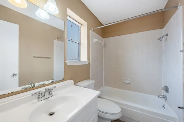 an empty room with a ceiling fan and a fan