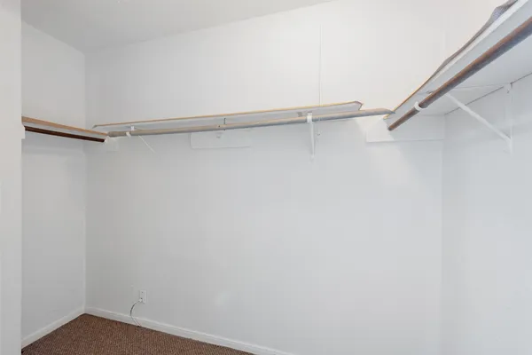 an empty room with a ceiling fan and a bathroom
