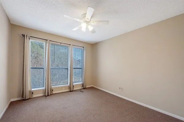 a bathroom with a bathtub shower sink vanity and toilet