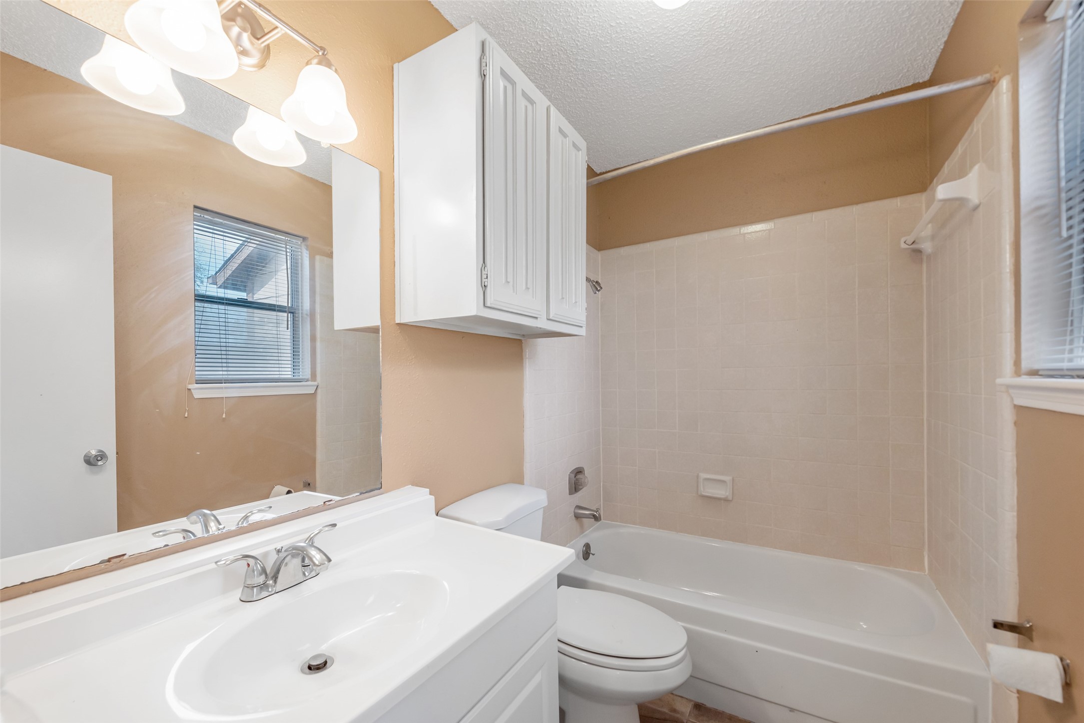 12400 Brookglade Circle, Unit 15 Houston, TX 77099 - Photo 30 of 43 a bathroom with a bathtub shower sink vanity and toilet