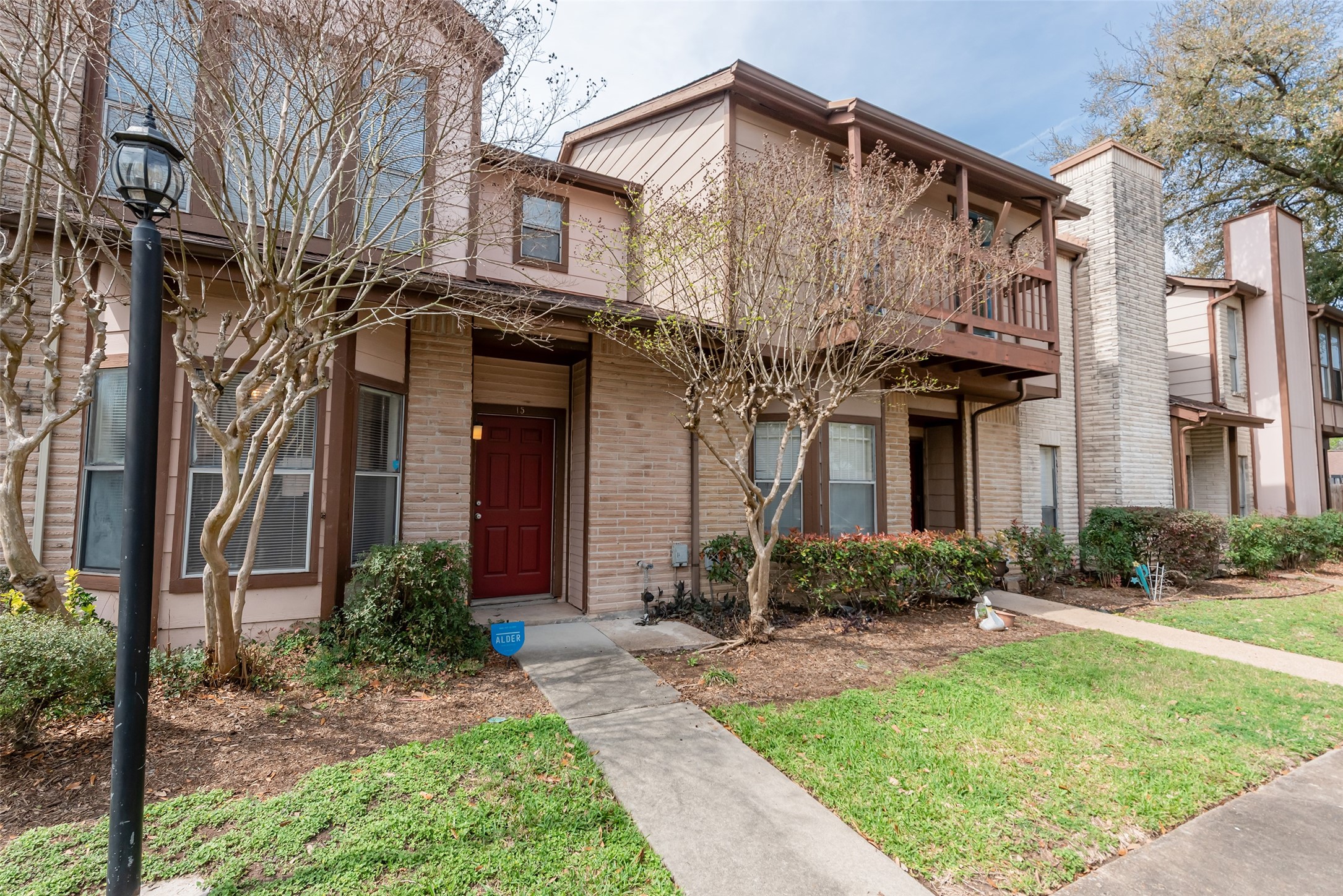 12400 Brookglade Circle, Unit 15 Houston, TX 77099 - Photo 36 of 43 a view of a house with brick walls and a yard with plants