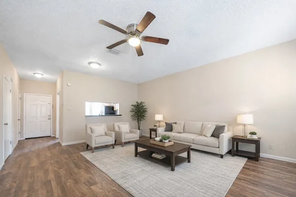 a view of a room with wooden floor and white walls