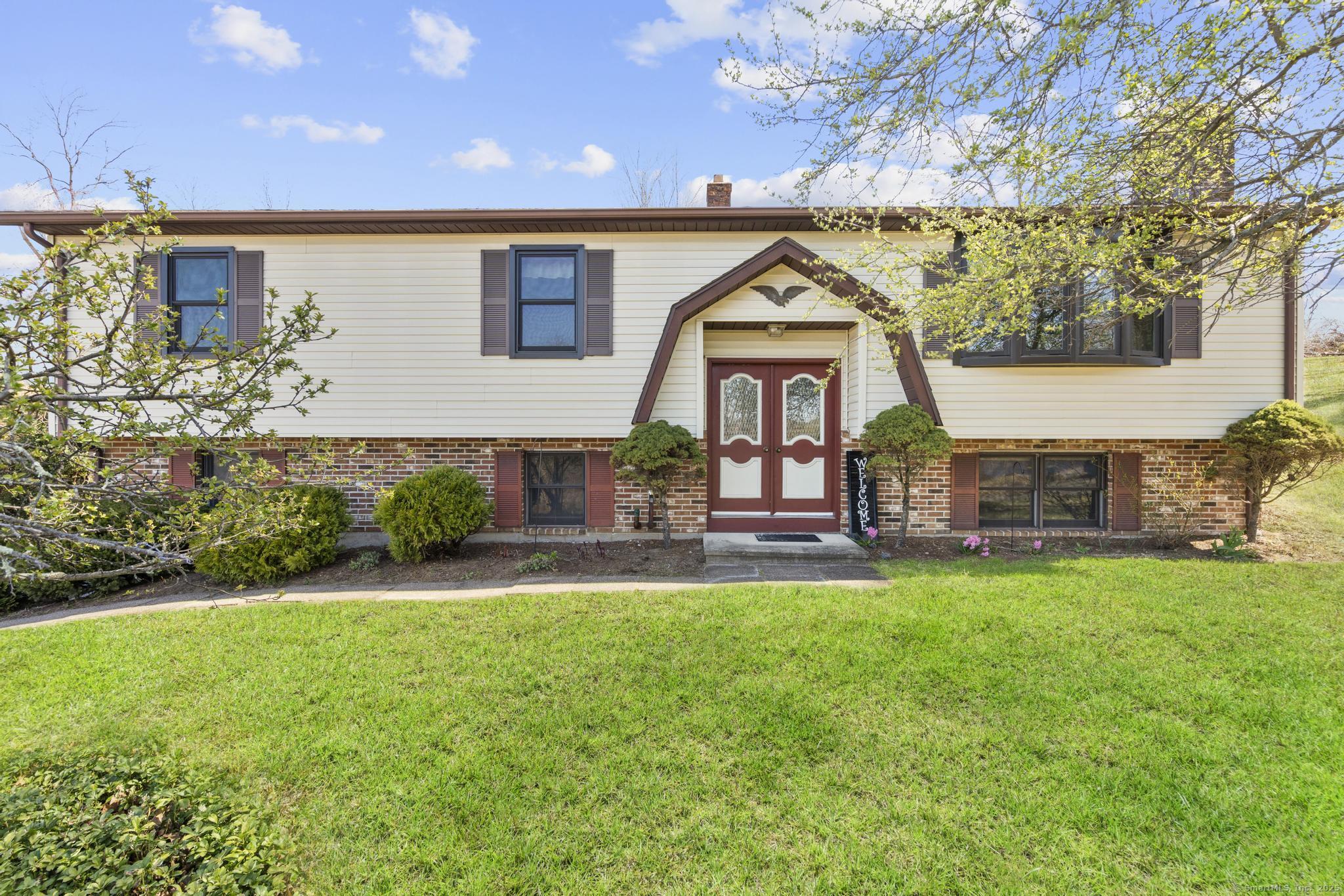 a front view of a house with garden