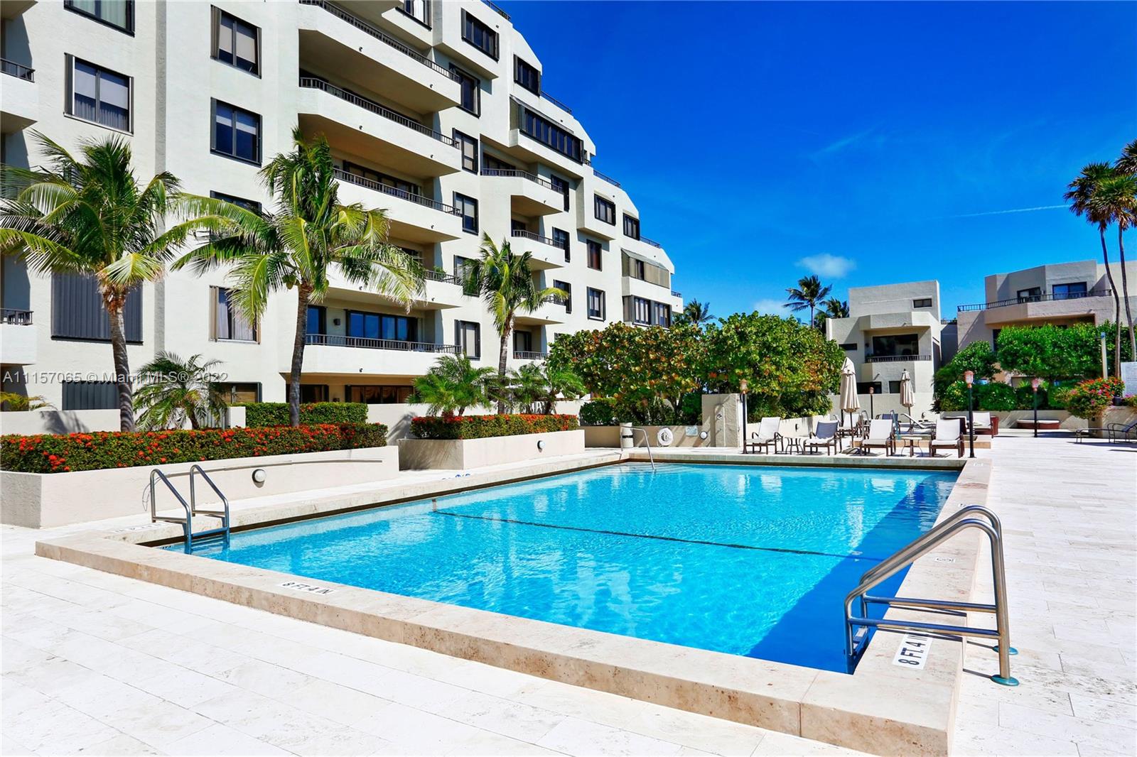201 Crandon Boulevard, Unit 720 Key Biscayne, FL 33149 - Photo 5 of 9 a view of building with outdoor seating and swimming pool