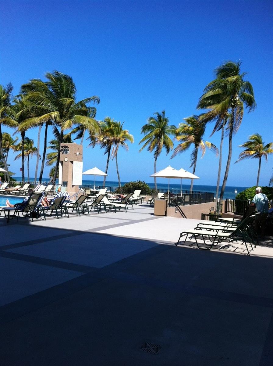 201 Crandon Boulevard, Unit 720 Key Biscayne, FL 33149 - Photo 6 of 9 a view of a house with a yard and sitting area