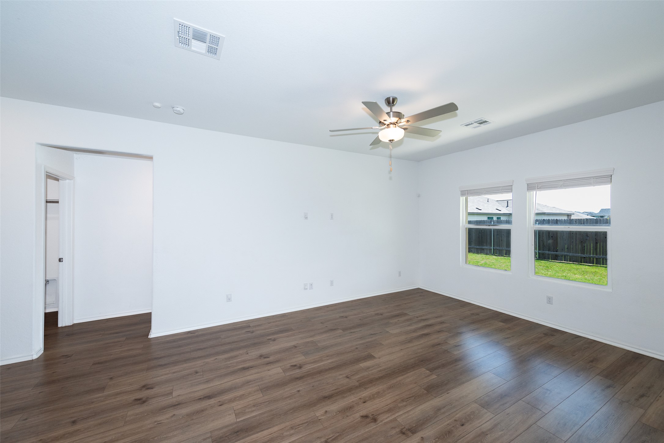 147 Otter Road Kyle, TX 78640 - Photo 11 of 34 to your left leads to the laundry room and primary bed/bath to the right of that