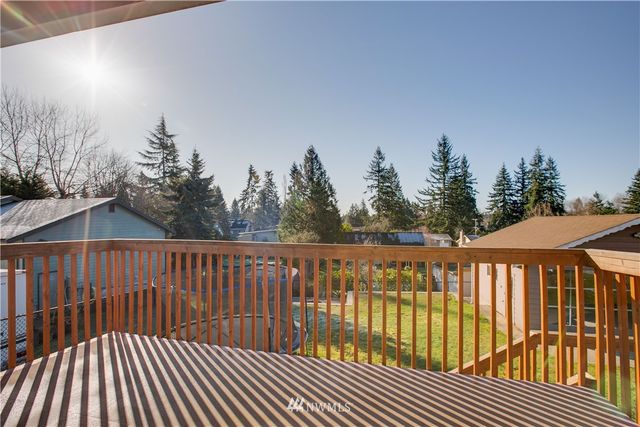 a view of a roof deck with wooden floor and fence