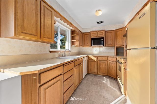 a kitchen with sink cabinets and window